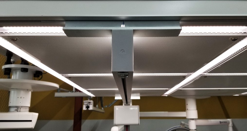 A patient lift suspended from an AirFRAME integrated ceiling system